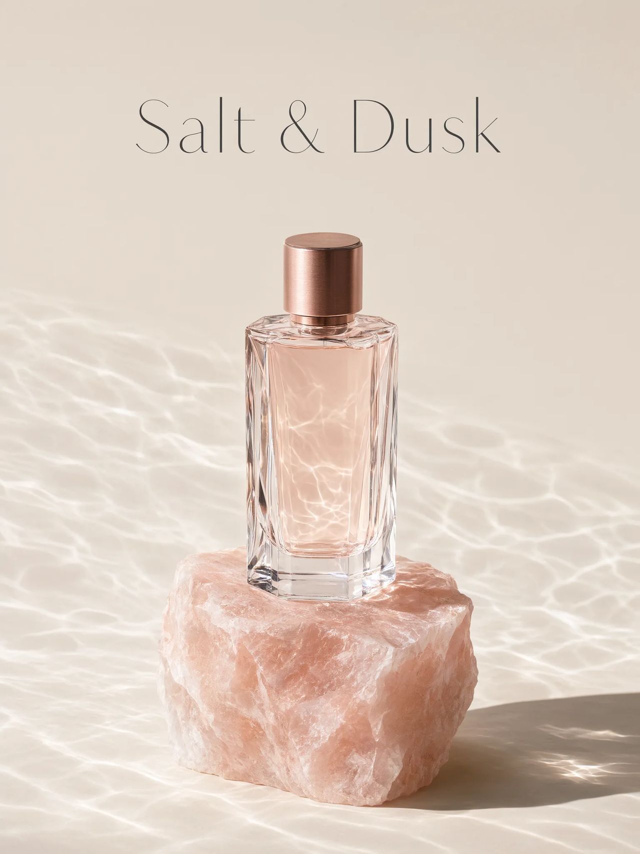 A faceted glass perfume bottle on a raw pink salt crystal in rippling light, the words Salt & Dusk set above it.