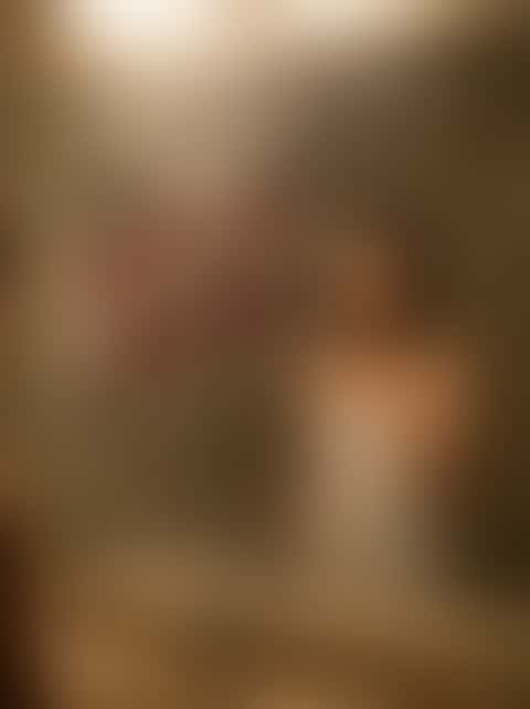 The words WAIT UP FOR ME written in red lipstick on a steamed mirror beside a woman's reflection.