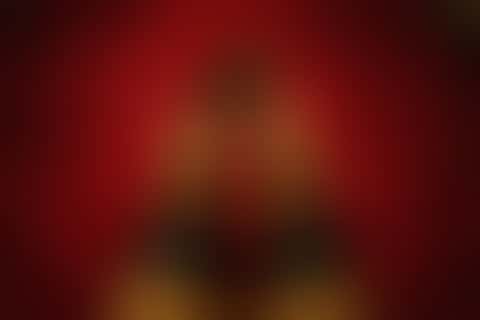 First-person view across red satin, bars of light from a window blind moving slowly through the frame.