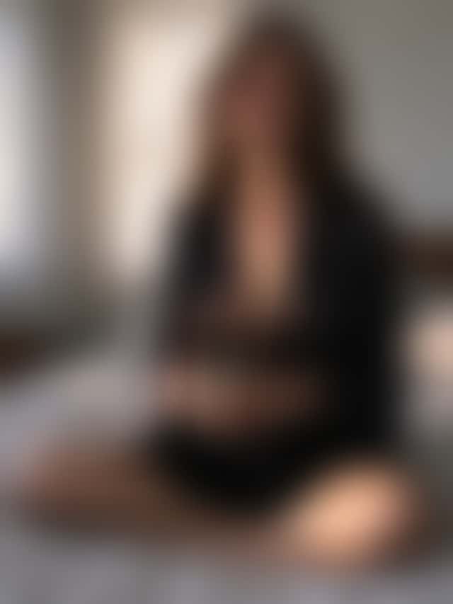 The same woman, face, hairstyle, pose, cup and bed unchanged, now in a black silk wrap, with the morning light turned into slanting afternoon sun.